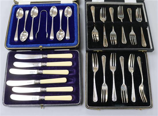 Four cased sets of silver cutlery, including cake forks and teaspoons.